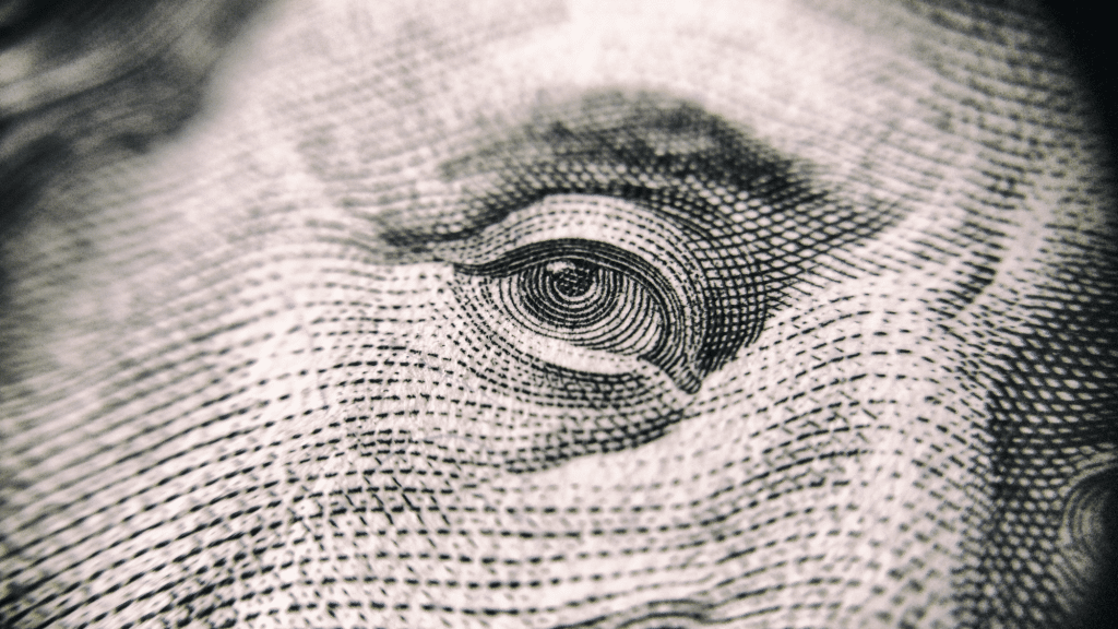 closeup of Benjamin Franklin's eye on the $100 dollar bill